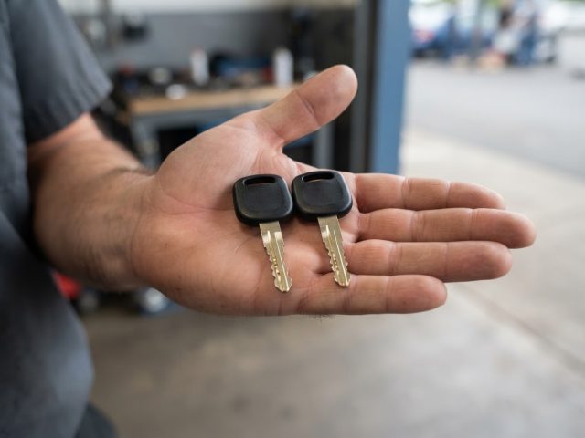 Open hand holding two duplicate transponder keys